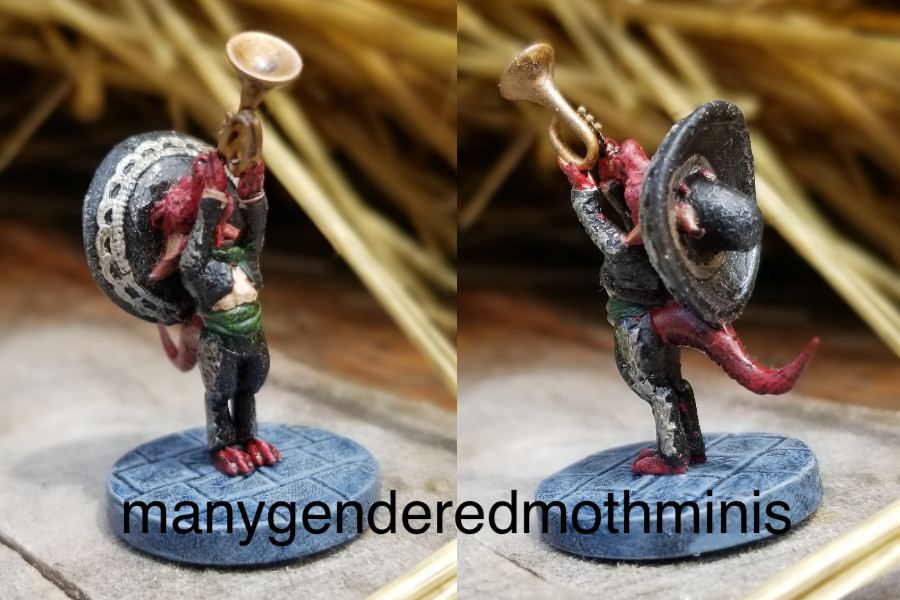 A red kobold in a black mariachi suit tooting a trumpet.