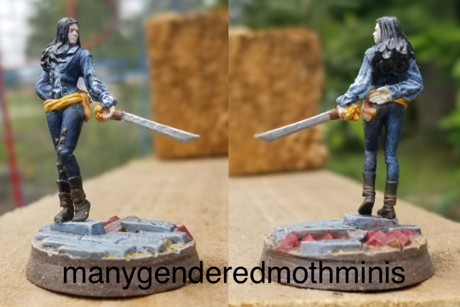 A woman in trousers and a waistcoat, poised with a rapier.