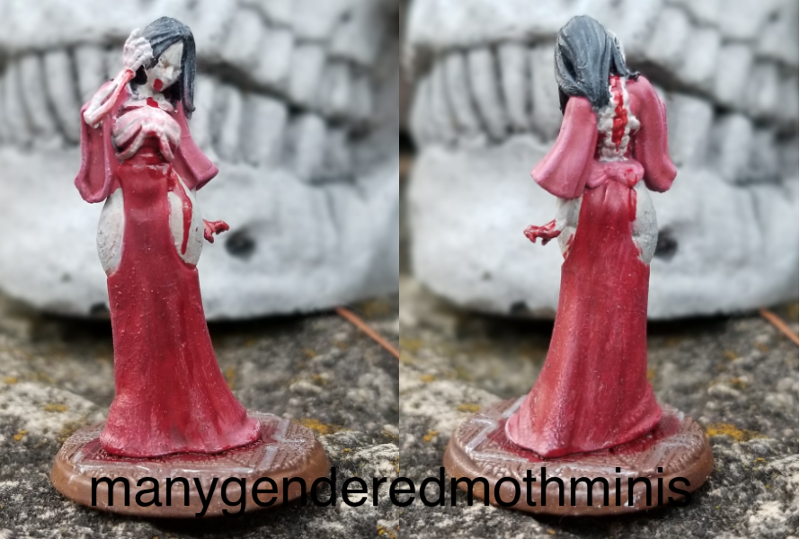 A woman with her rib cage exposed wearing a dress painted to look like flayed human flesh.